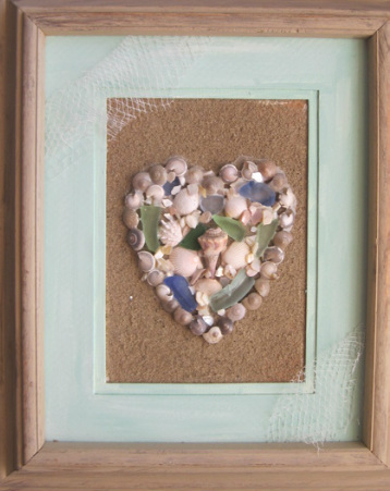 Beautiful shell heart on sandy background. Find out how to make your own at www.shellcrafter.com