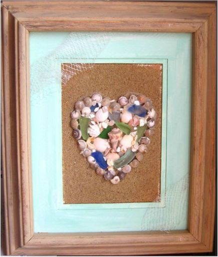 Beautiful heart made out of shells on a sand background. www.shellcrafters.com, with tutorials!